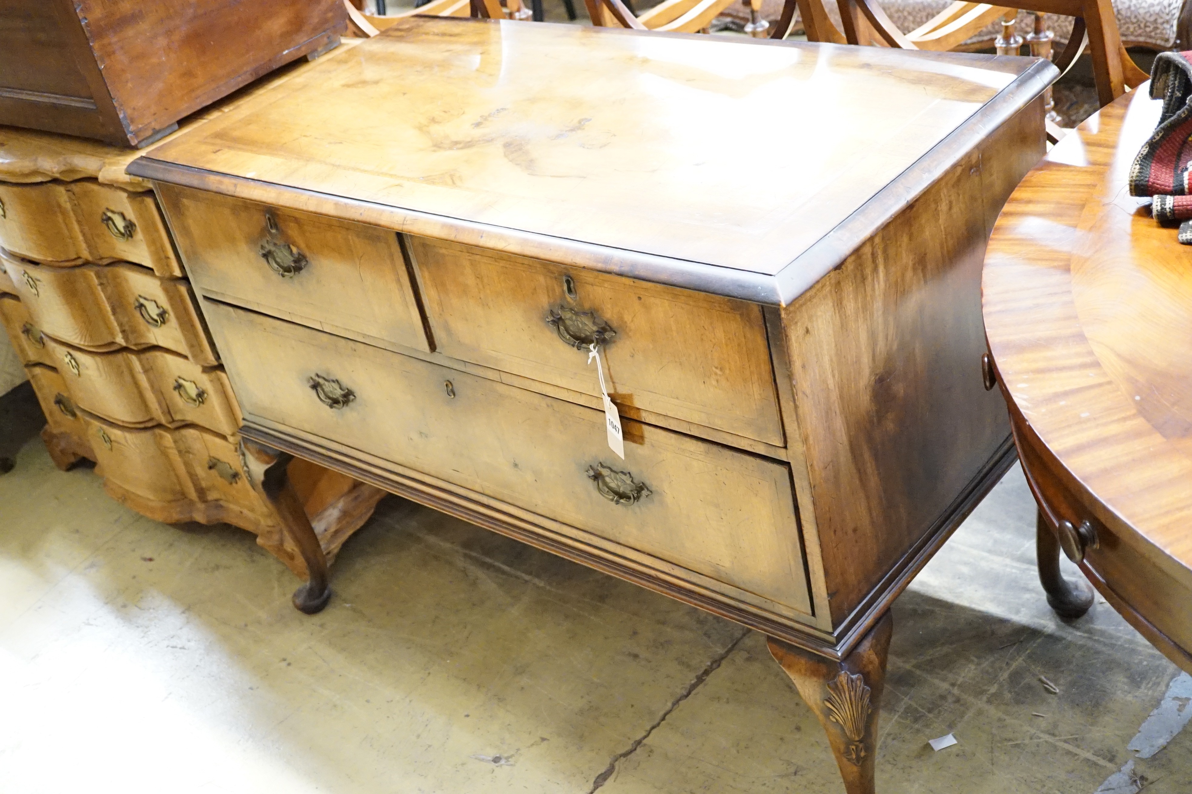 A Queen Anne style walnut chest of three drawers on cabriole legs, width 111cm, height 83cm